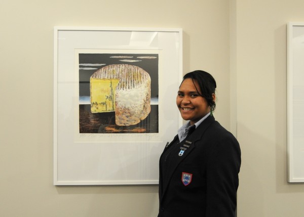 Head Girl Julia-May Aramoana standing in front of Dick Frizzell painting  
